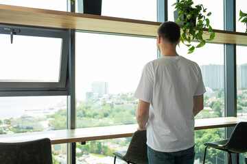 A cheerful young entrepreneur works in a modern workspace