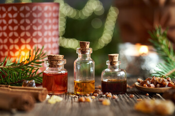 Bottles of essential oil with frankincense and myrrh resin at Christmas - obrazy, fototapety, plakaty