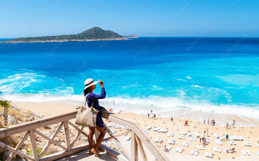 Wall mural Kaputas beach Lycia coast Turkey Kaputas Beach, young Asian women looking out over the Mediterranean Sea on a sunny day, Kas, Turkey.