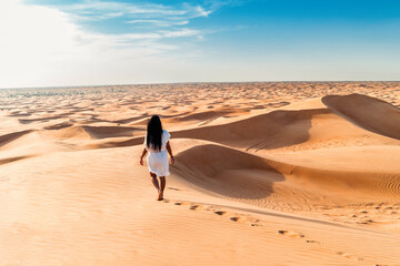 Dubai dessert sand dunes, Asian woman on Dubai desert safari, United Arab Emirates vacation, woman...