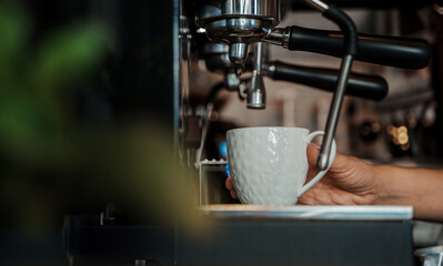 An intricate espresso machine pours fresh coffee into an elegant white cup, capturing the essence...