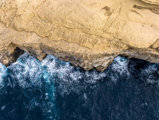 Aerial View of Gozo island in Malta. Rocky shores from above—an aerial snapshot revealing the island's untamed coastal allure.