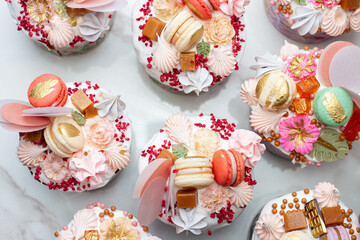 Obraz na płótnie Canvas Beautiful traditional Orthodox Easter cakes decorated with glaze, meringues, chocolate, nuts, toffees, macaroons, flowers and jelly