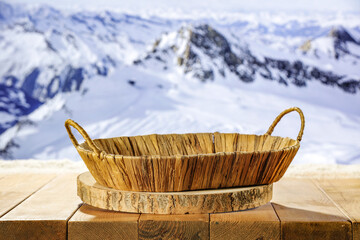 Fototapeta premium Desk of free space and winter landscape of mountains. Board with pedestal. Mockup background and winter december time. 