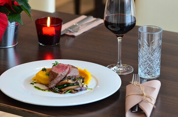 beef fillet mignon with puree on white plate,