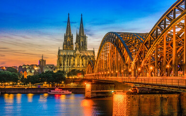 Cologne Koln Germany during sunset, Cologne Hohenzollern bridge with the cathedral in the background during sunset. beautiful sunset at the Rhine River - obrazy, fototapety, plakaty