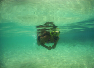 a woman snorkeling in the crystal clear waters of the Caribbean Sea