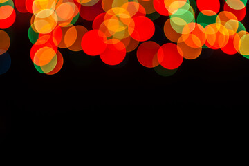 Christmas defocused lights, blurred colorful lights on a dark background, festive background, copy...