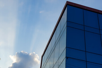 Fototapeta na wymiar glass buildings with cloudy blue sky background