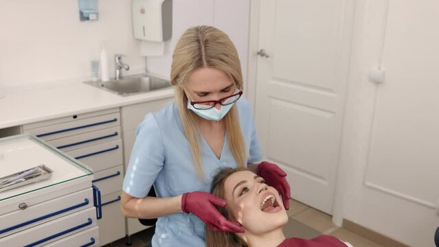 Jaw diagnosis, Orthodontic checkup, Jaw care. Orthodontic and gnathological examination female patient's jaw joints is being conducted by doctor.
