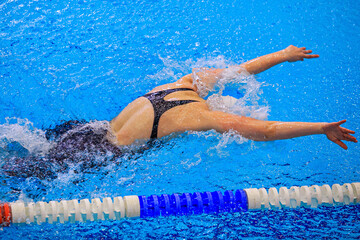 female swimmer swim butterfly stroke competition race, summer sports games
