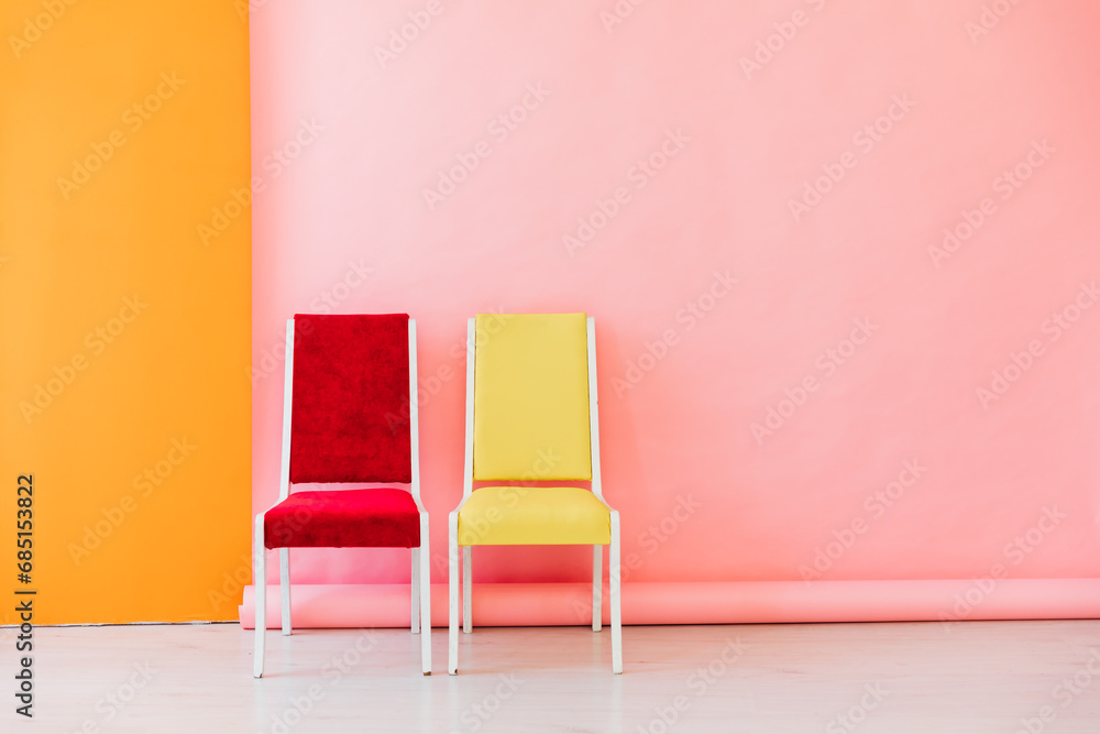 Wall mural Interior of a pink room with colored chairs, armchairs