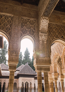 From below of Moorish arches in the Court of the Lions at Alhambra, in Granada, Spain