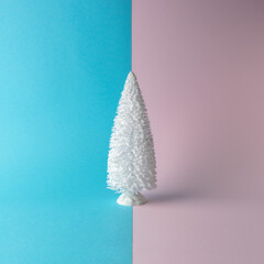 Snowy Christmas tree on bright background. Christmas or New Year minimal concept.