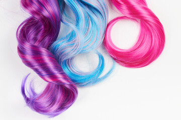 Natural looking shiny hair of different bright colors, cosplay wig on a white background