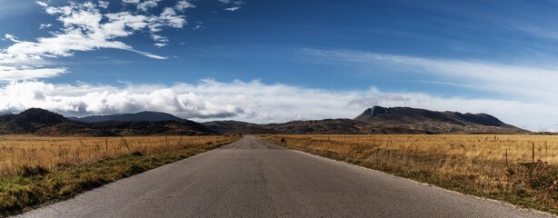 country highway leading into the distance in the Gran Sasso and Monti della Laga National Park in the Apennine mountains of Italy