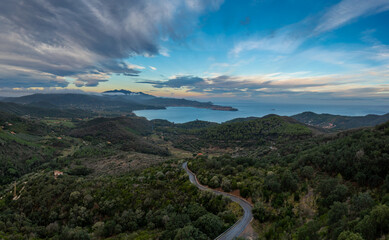 view of curvy mountain road and Portoferraio Bay on Elba Island at sunrise
