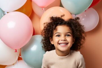 Fototapeta na wymiar Happy latin little girl excited looking up in the balloons