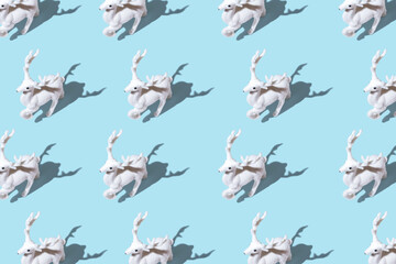 Creative Christmas pattern made of Christmas reindeer on bright blue background. Minimal Christmas or New Year concept.