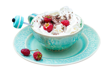 A beautiful blue cup of coffee with whipped cream, cocoa powder and raspberries on rustic wooden background