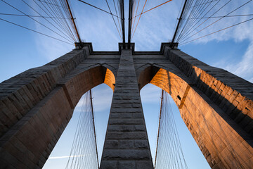 Architectural detail of the Brooklyn Bridge in New York City in the beautiful warm sunrise light.