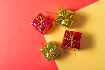 Gift boxes on a red and yellow background with copy space.