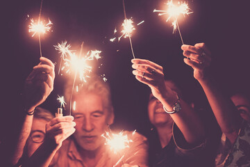 Group of people with mixed ages celebrate together new year or party event holiday. Family have fun...