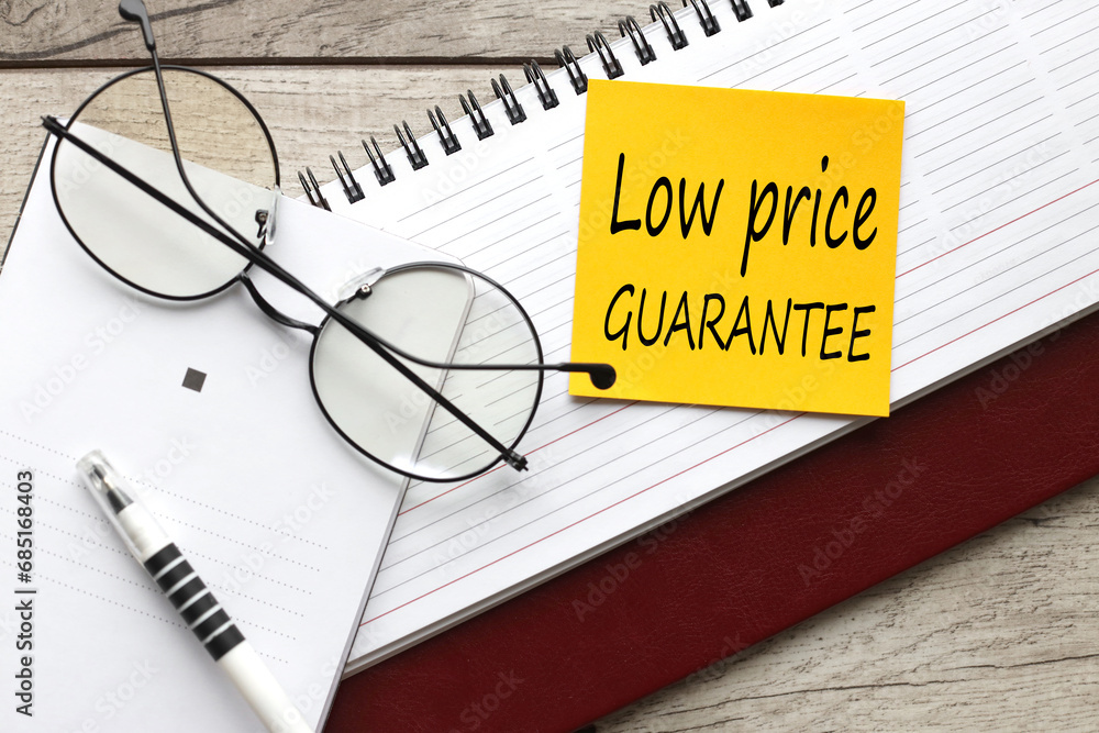 Poster low price guarantee top view of text on notepad. glasses