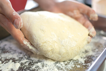 Levitated and Puffed Bread Dough with circular shape and sprinkled flour