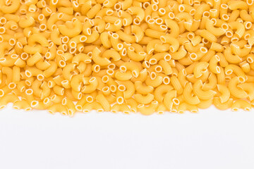 Uncooked Chifferi Rigati Pasta Scattered on White Table. Fat and Unhealthy Food. Classic Dry Macaroni. Italian Culture and Cuisine. Raw Pasta