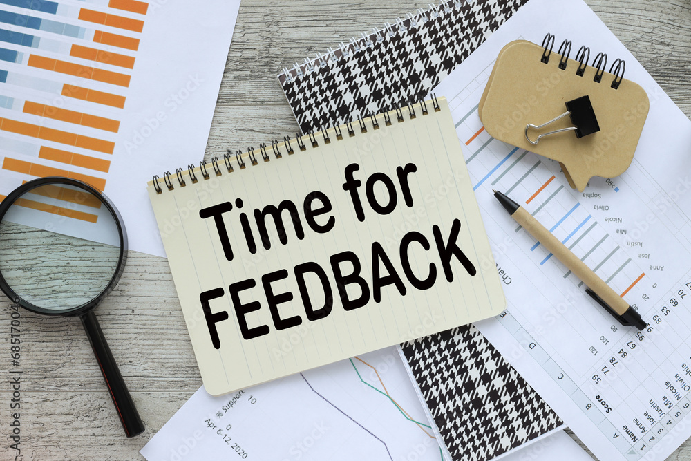 Poster time for feedback top view of a notebook with text. financial charts, pen