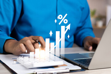 Interest rate concept, Business man using calculator with graph percentage symbol and up arrow,...