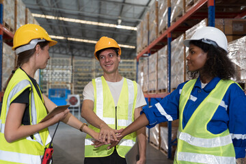 Warehouse and completed, finish job concept. Male and female warehouse workers join hands at the storage warehouse