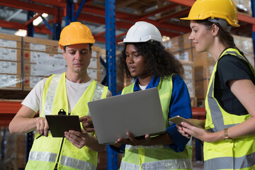 Warehouse and storage concept. Male and female warehouse workers working together at the storage warehouse. Group of warehouse workers discuss and training work in distribution branch © amorn