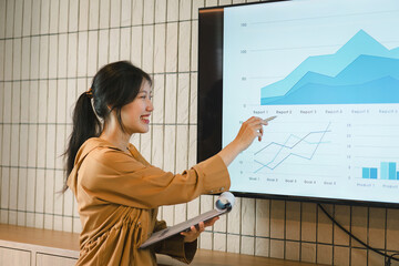 The female Chief Analyst is conducting a meeting presentation for a team of economists. The...