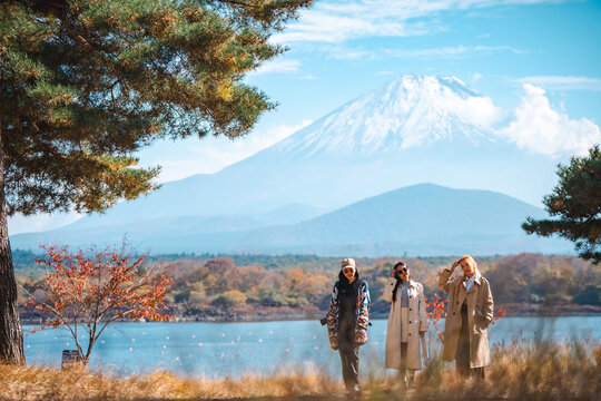 Happy tourist traveler woman or man enjoying on lake kawaguchiko with mount fuji in japan, spring and summer, Japan travel vacation site