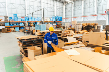 paper cardboard manufacture factory concept, industry worker person working with machine to recycling material package box in warehouse storage or plant production for global logistic business