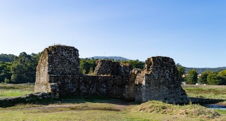 Fototapeta na wymiar medieval castle ruins in the countryside with blue sky