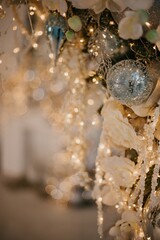 Modern New Year's decor for the living room and bedroom. Christmas tree, decorated with New Year's toys, stands near the fireplace