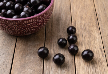 Jabuticabas on a bowl over wooden table