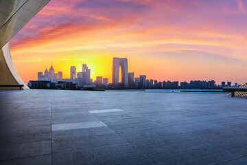 City square and skyline with modern buildings at sunset in Suzhou, Jiangsu Province, China. Empty...