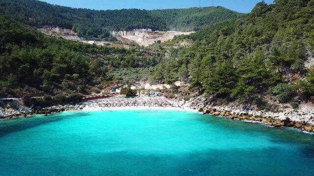 Marble Beach or Saliara Beach in Thassos Island , Greece , well known tourist attraction at Aegean Sea , famous for it's pure white marble sand ,aerial drone footage