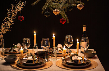 winter holidays, dinner party and celebration concept - scandinavian christmas table serving with burning candles at home at night