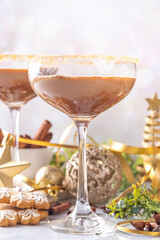 Christmas Gingerbread martini cocktail, spicy winter alcohol cocktail with gingerbread syrup, on New Year Xmas decorated background 