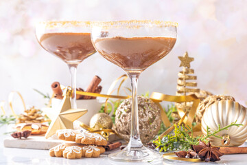Christmas Gingerbread martini cocktail, spicy winter alcohol cocktail with gingerbread syrup, on New Year Xmas decorated background 
