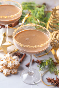 Christmas Gingerbread martini cocktail, spicy winter alcohol cocktail with gingerbread syrup, on New Year Xmas decorated background 