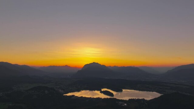 Sunset timelaps with Faaker See and the Dobratsch mountain in the background
