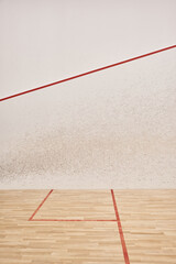 spacious and modern squash court with white walls and polished floor, motivation and determination