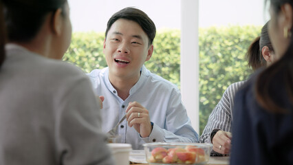 Gen Z asia people group save the planet earth relax eating food go green meal eco friendly glass lunch box reduce plastic waste free water bottle at table SDGs office. ESG net zero happy staff team.