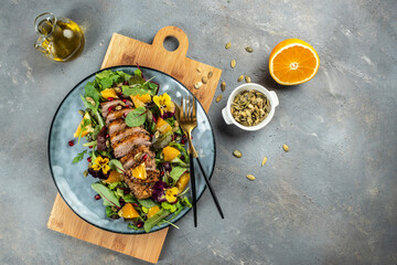 duck salad with citrus on plate. Menu, recipe mock up, banner. copy space for text. top view - obrazy, fototapety, plakaty